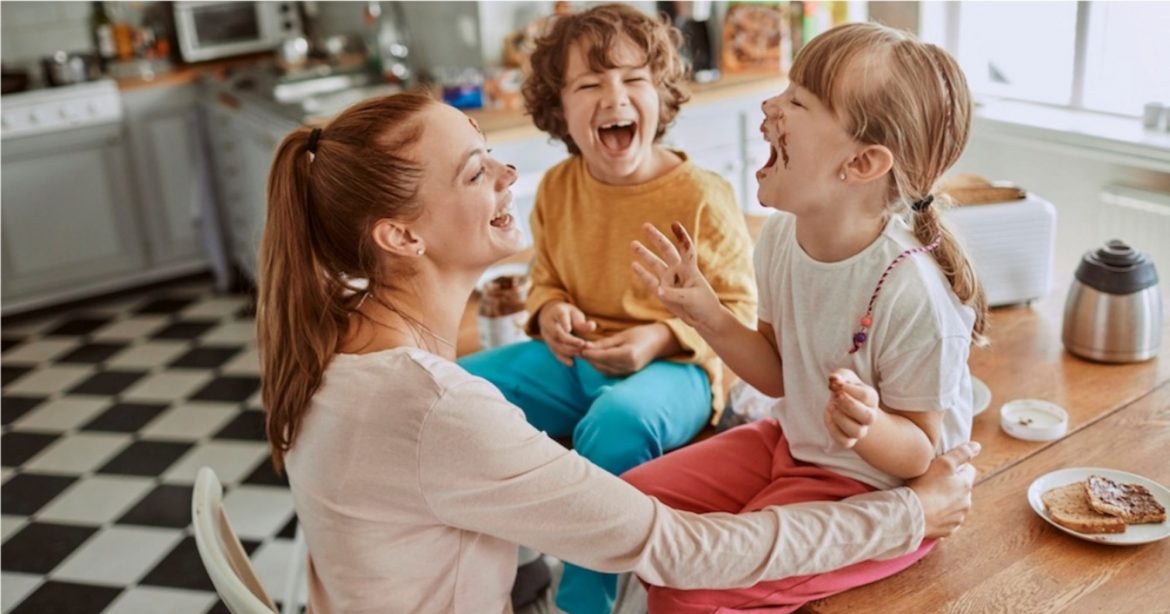 mom laughing with two kids